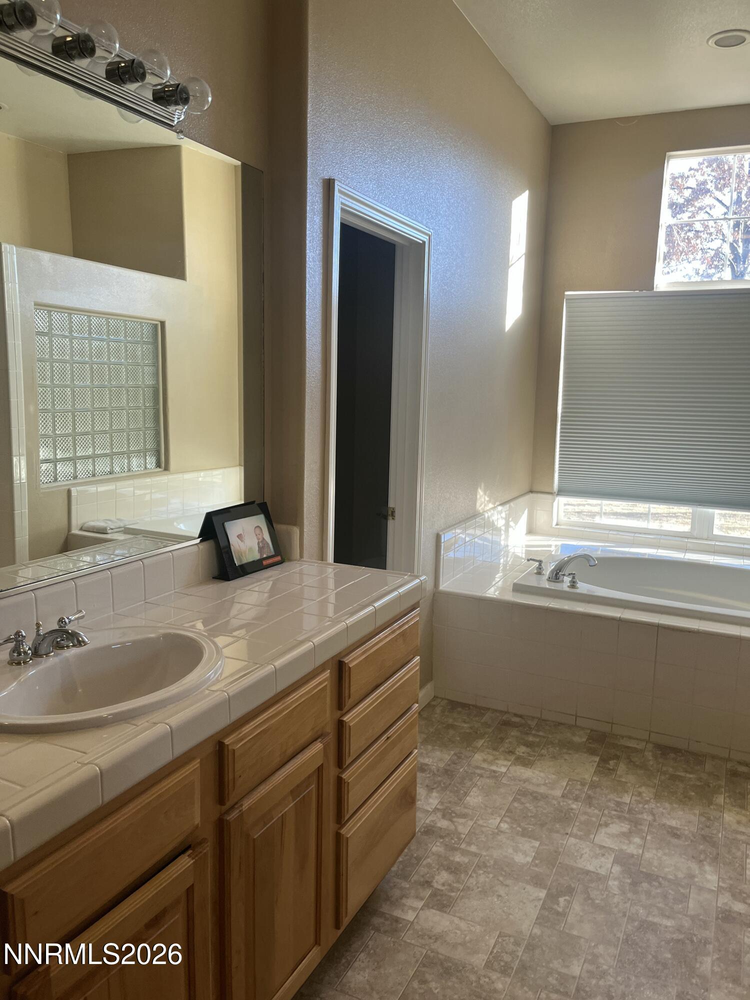 1895 Vintner Court Reno, NV 89519 - Photo 25 of 30 a bathroom with a sink and a mirror