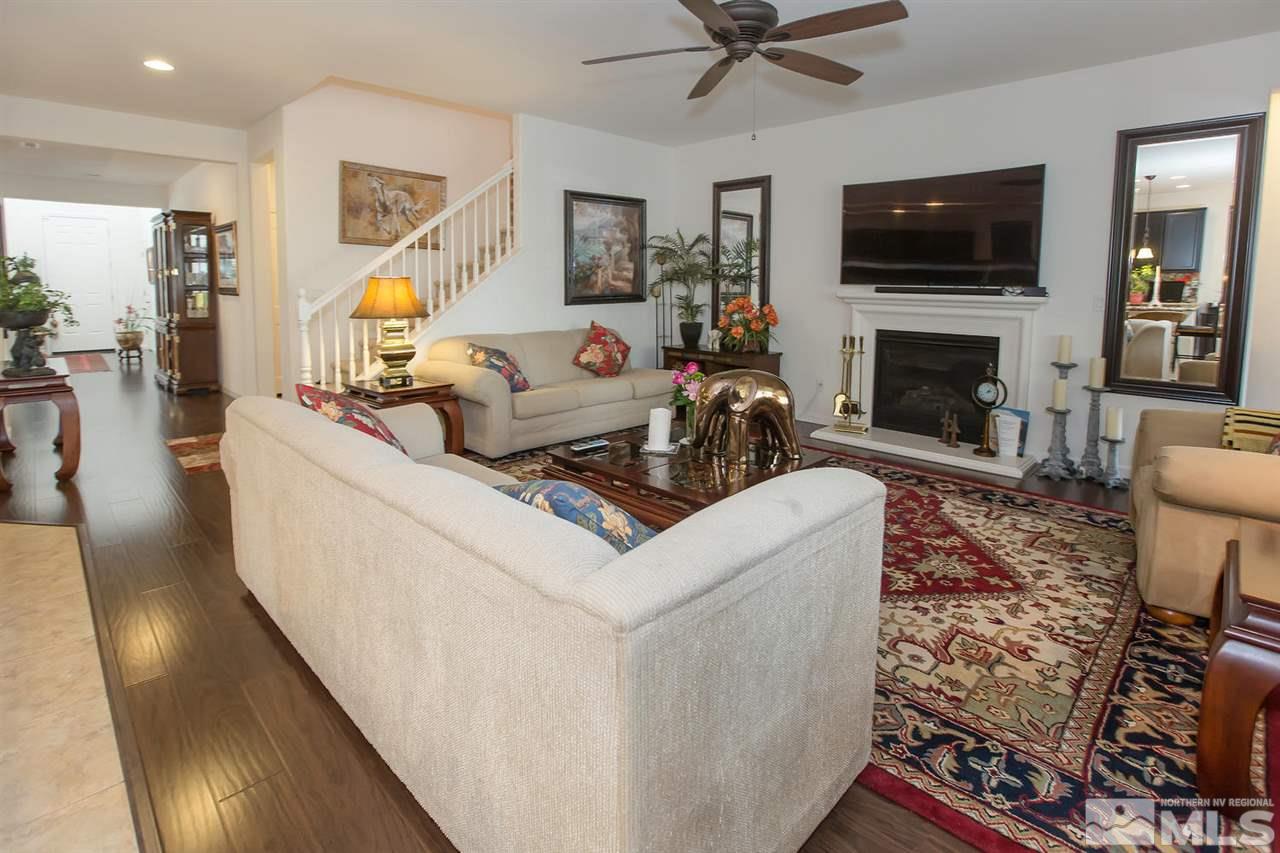2025 Horse Prairie Road Reno, NV 89521 - Photo 6 of 25 a living room with furniture a flat screen tv and a fireplace