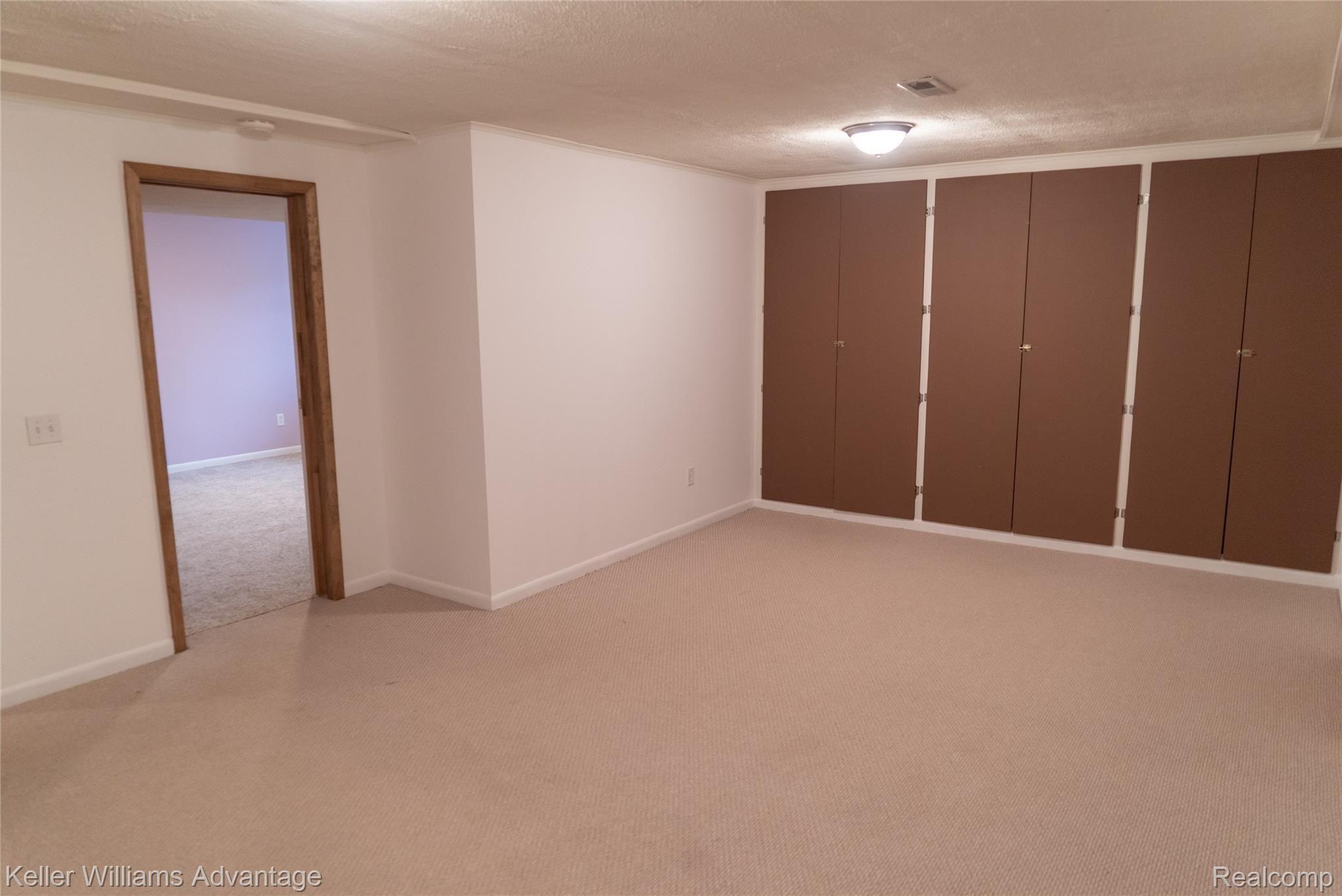 6705 Hogback Lake Road Davisburg, MI 48350 - Photo 15 of 18 Additional Built In Storage throughout the Basement