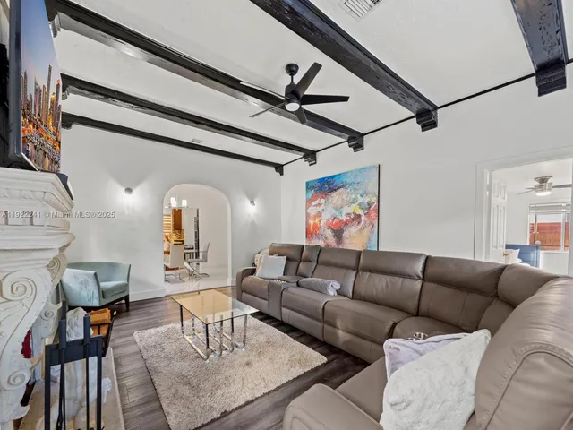 a living room with furniture and a ceiling fan