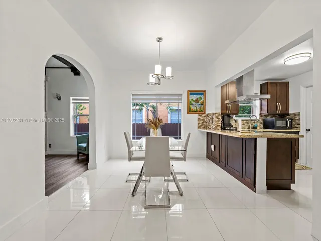 a kitchen with stainless steel appliances granite countertop a sink and a refrigerator