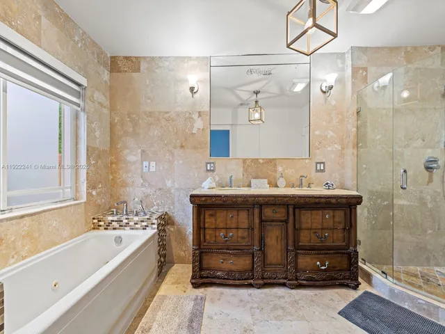 a spacious bathroom with a granite countertop sink mirror and a shower