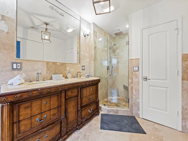 a spacious bathroom with a tub sink and mirror