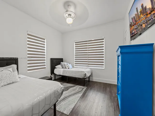 a bedroom with bed and a window