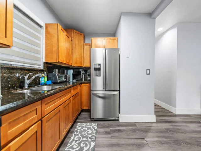 a utility room with dryer washer and a mirror