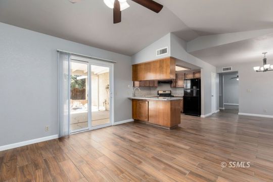601 South Gold Canyon Street Ridgecrest, CA 93555 - Photo 16 of 34 a kitchen with stainless steel appliances granite countertop a refrigerator and a stove top oven