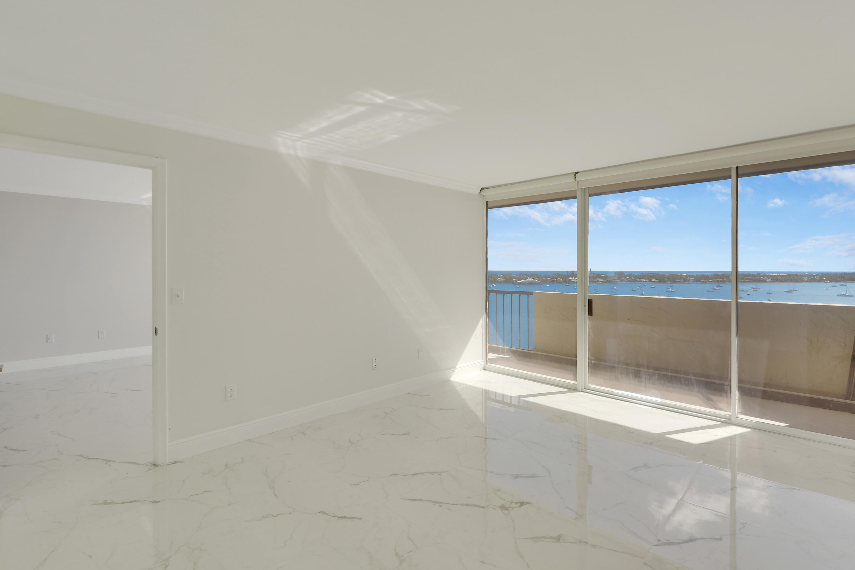 5200 North Flagler Drive, Unit 1404 West Palm Beach, FL 33407 - Photo 11 of 26 an empty room with sliding glass door