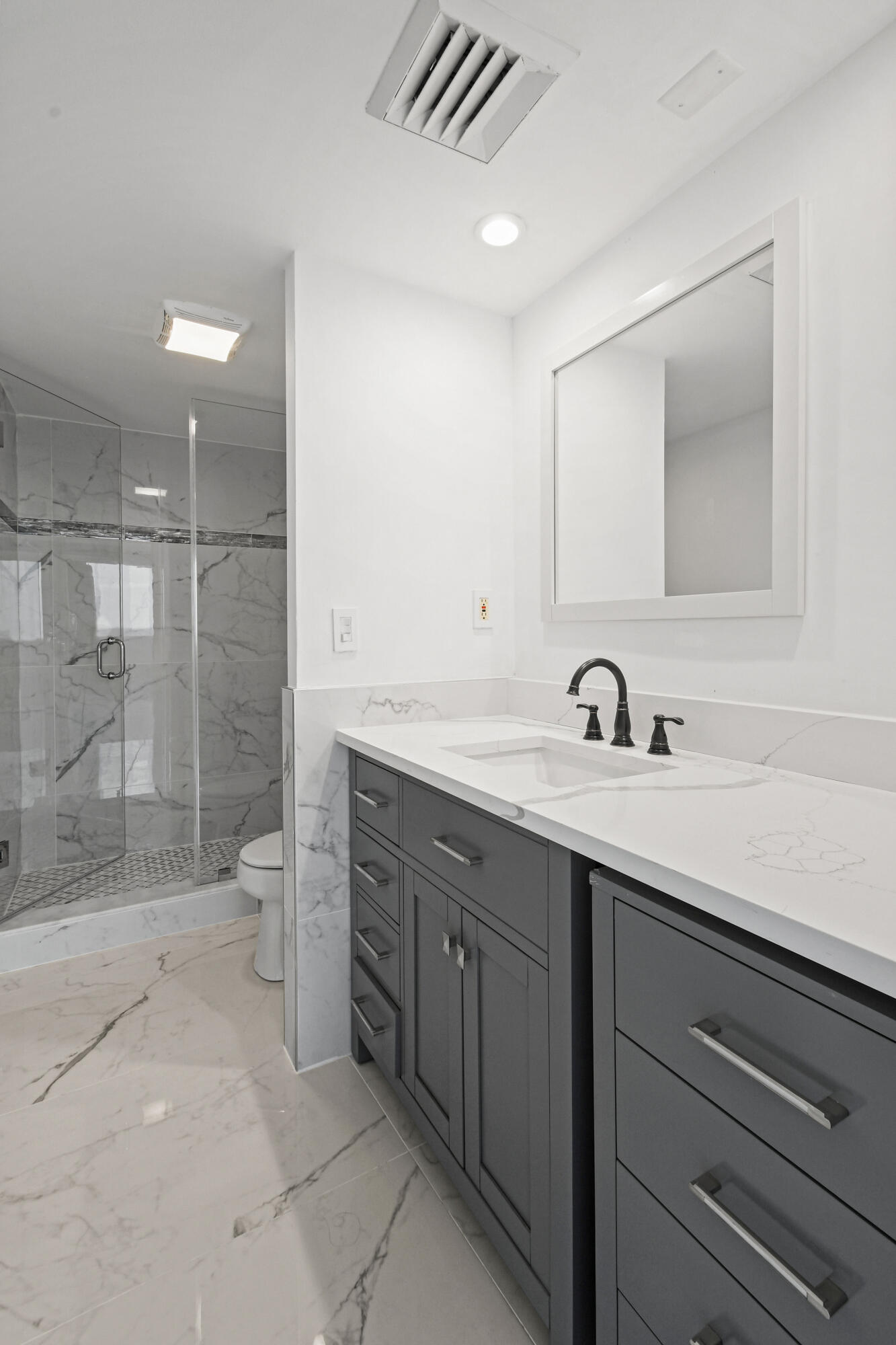 5200 North Flagler Drive, Unit 1404 West Palm Beach, FL 33407 - Photo 14 of 26 a spacious bathroom with a shower sink and mirror