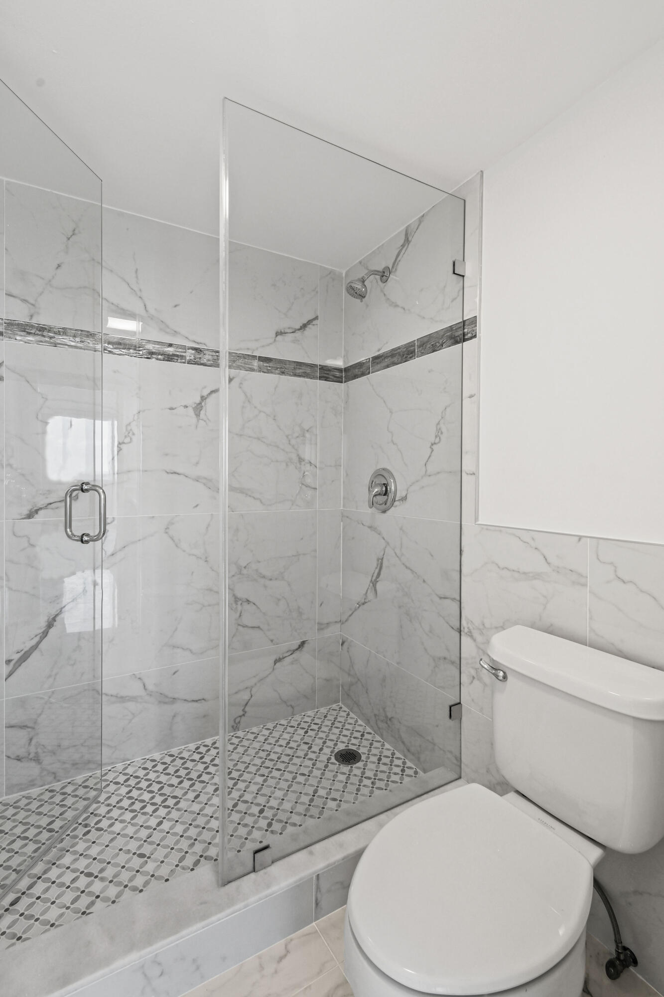5200 North Flagler Drive, Unit 1404 West Palm Beach, FL 33407 - Photo 15 of 26 a white toilet and shower