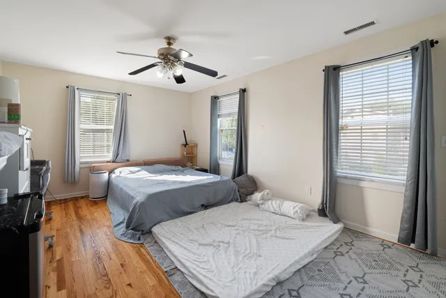 a bedroom with a large bed and a window