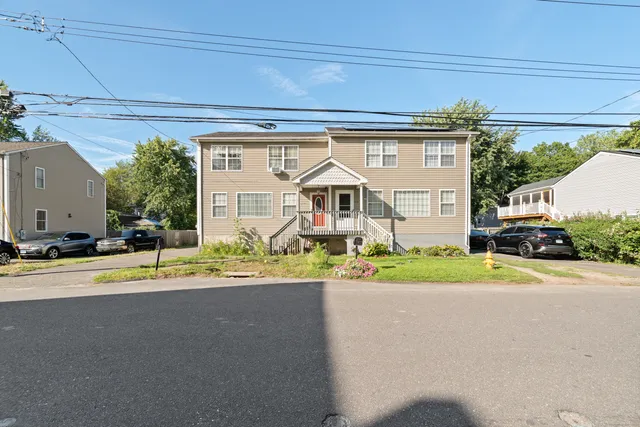 a front view of a house with a yard and a garage
