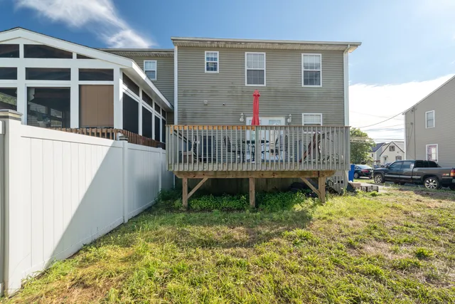 a view of a house with backyard and porch