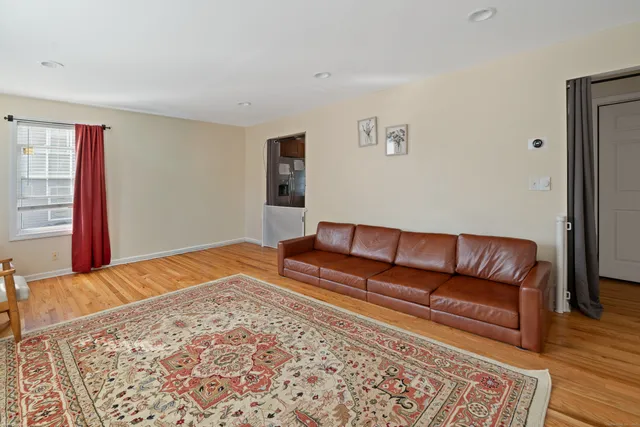 a living room with a couch and wooden floor