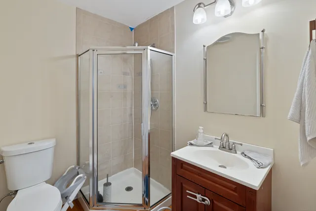 a bathroom with a sink vanity mirror and toilet
