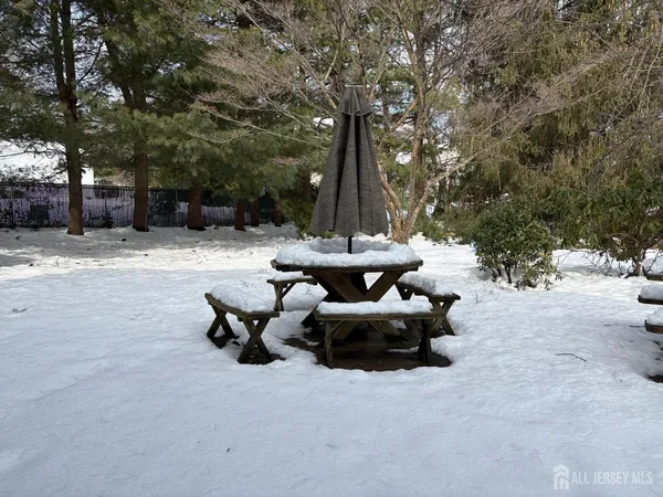 a view of a patio with fire pit and chairs