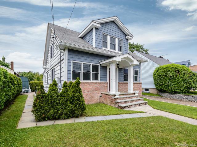 35 Birch Street Locust Valley, NY 11560 - Photo 1 of 27 a front view of a house with a yard