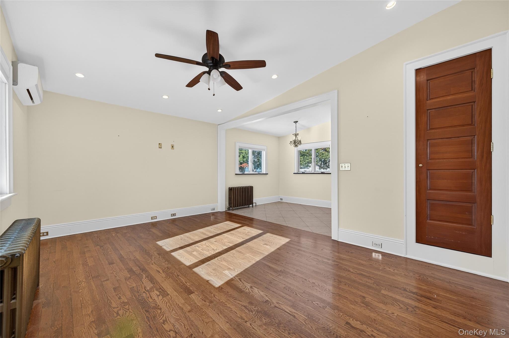 35 Birch Street Locust Valley, NY 11560 - Photo 11 of 27 a view of empty room with wooden floor and ceiling fan