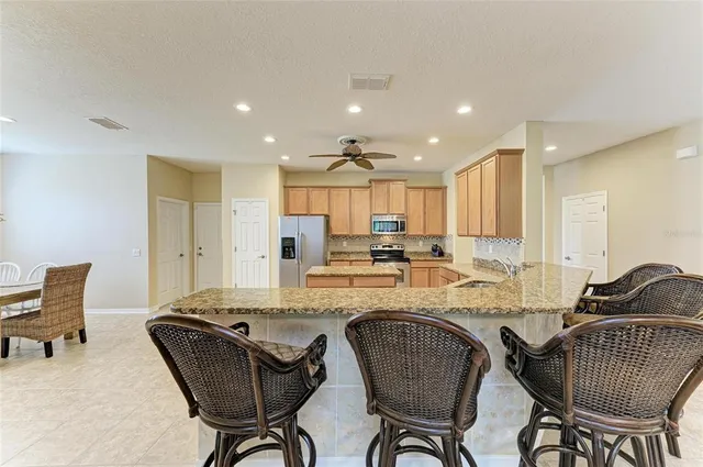 a kitchen with a refrigerator a stove top oven a sink and dishwasher