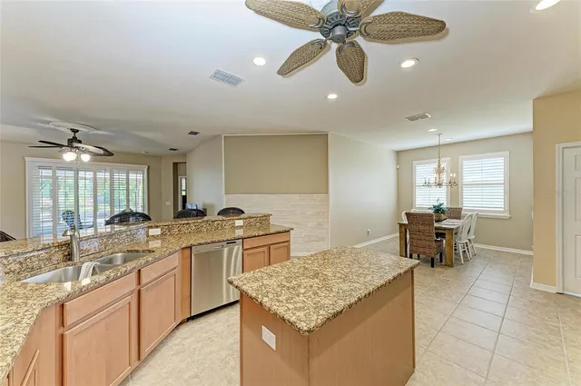 a view of a kitchen with granite countertop a sink and cabinets