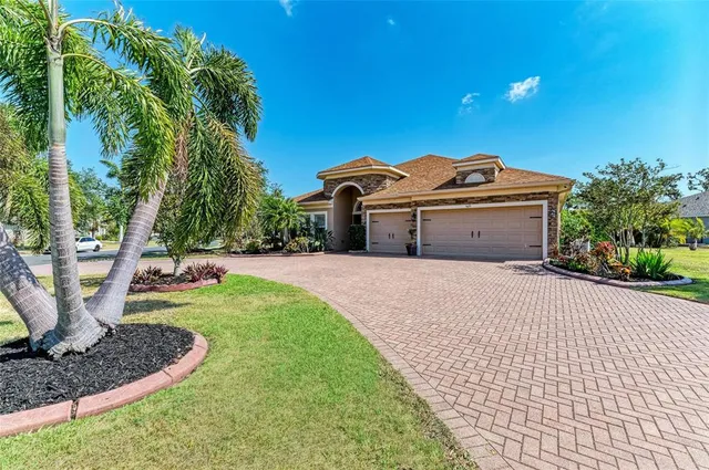 a view of a house with a yard and potted plants