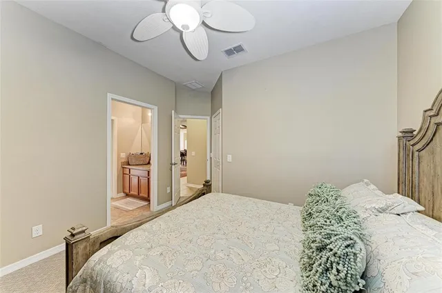 a bedroom with a bed and a lamp