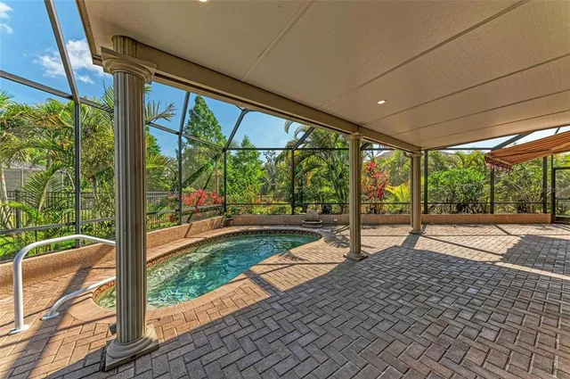 an aerial view of a house with a garden and lake view