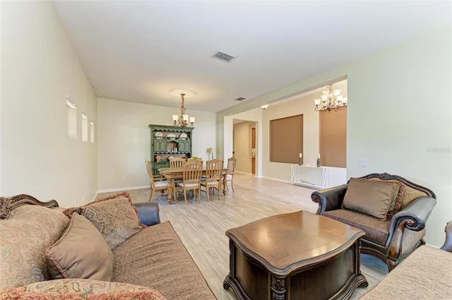 a view of a dining room with furniture wooden floor and chandelier