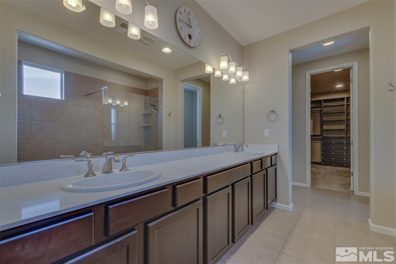2815 Bonfire Lane Reno, NV 89521 - Photo 11 of 22 a spacious bathroom with a granite countertop sink a light fixture and a mirror