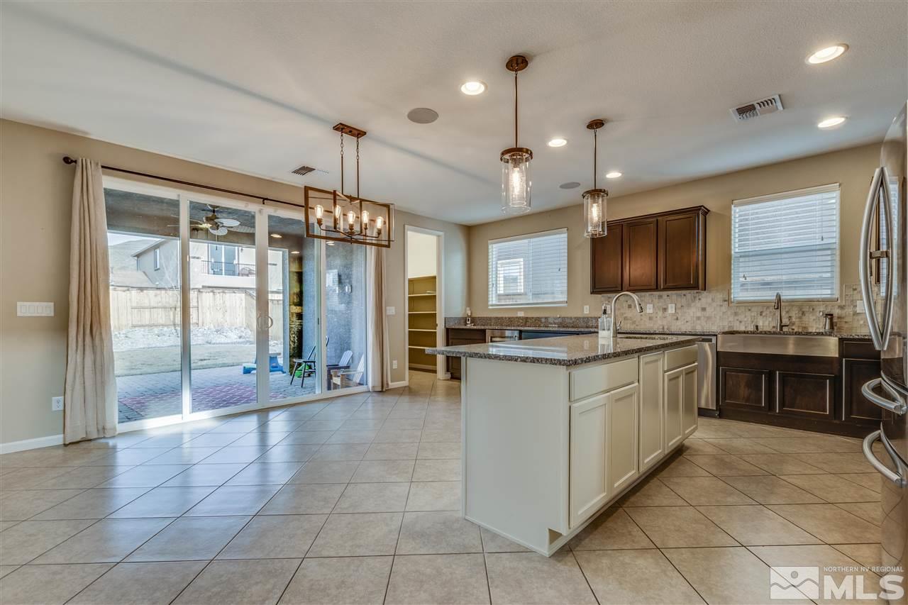2815 Bonfire Lane Reno, NV 89521 - Photo 3 of 22 a large kitchen with granite countertop a large stove top oven a sink a counter space and cabinets