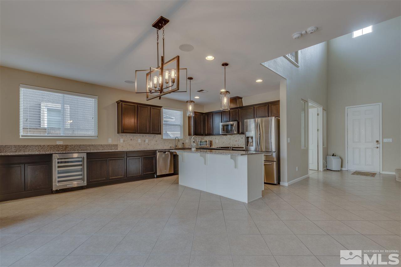 2815 Bonfire Lane Reno, NV 89521 - Photo 4 of 22 a view of kitchen with refrigerator stove microwave and cabinets