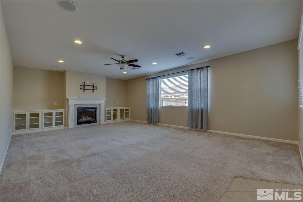 2815 Bonfire Lane Reno, NV 89521 - Photo 6 of 22 a view of an empty room with a fireplace and a window