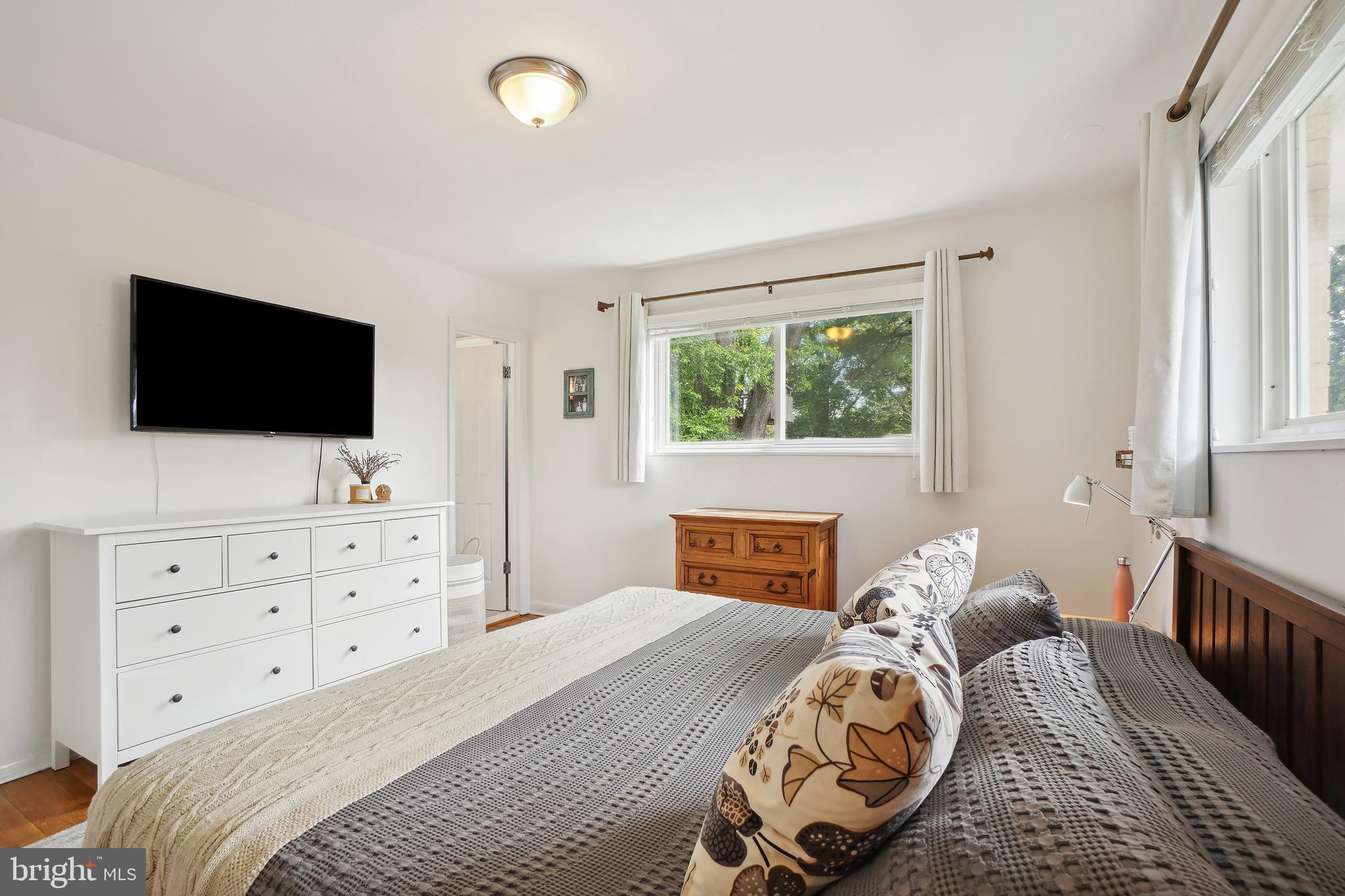 10403 Conover Drive Silver Spring, MD 20902 - Photo 15 of 38 a bedroom with a bed and a flat screen tv