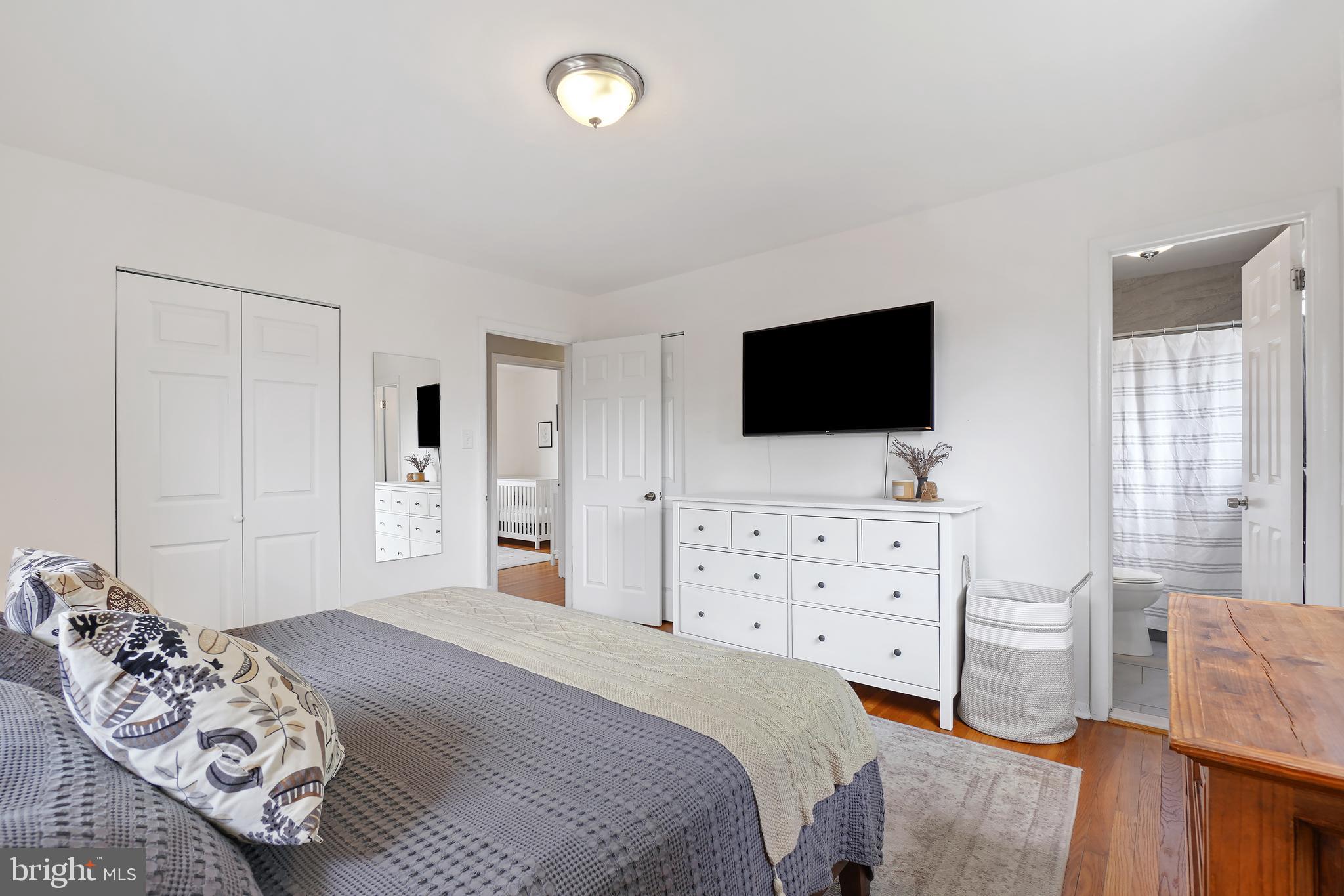 10403 Conover Drive Silver Spring, MD 20902 - Photo 16 of 38 a bedroom with a bed and a flat screen tv