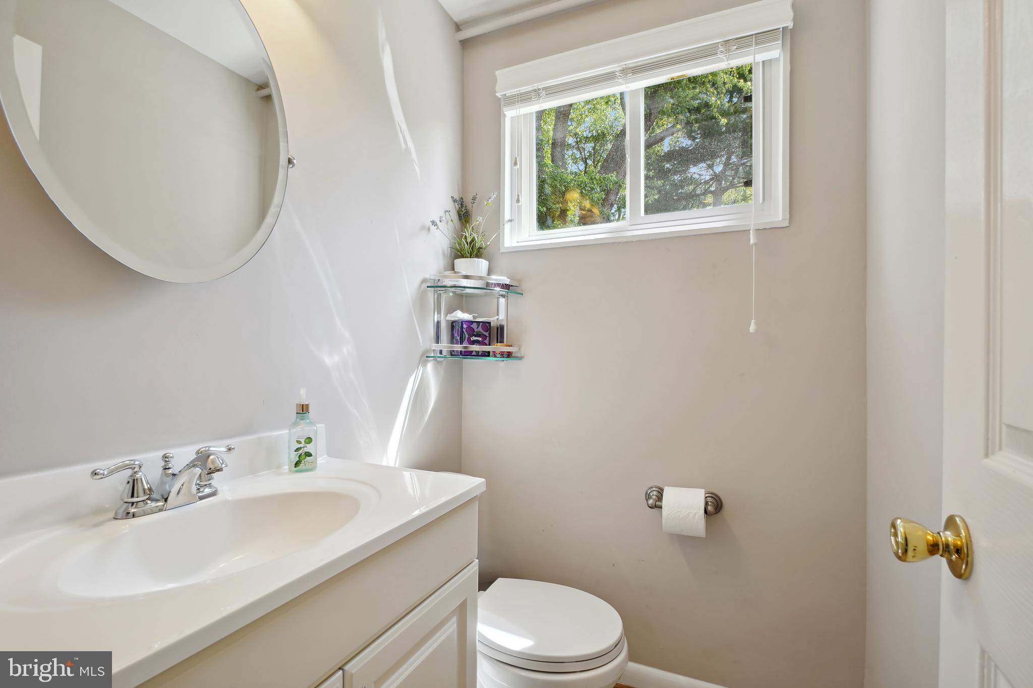 10403 Conover Drive Silver Spring, MD 20902 - Photo 28 of 38 a bathroom with a sink a toilet and a mirror