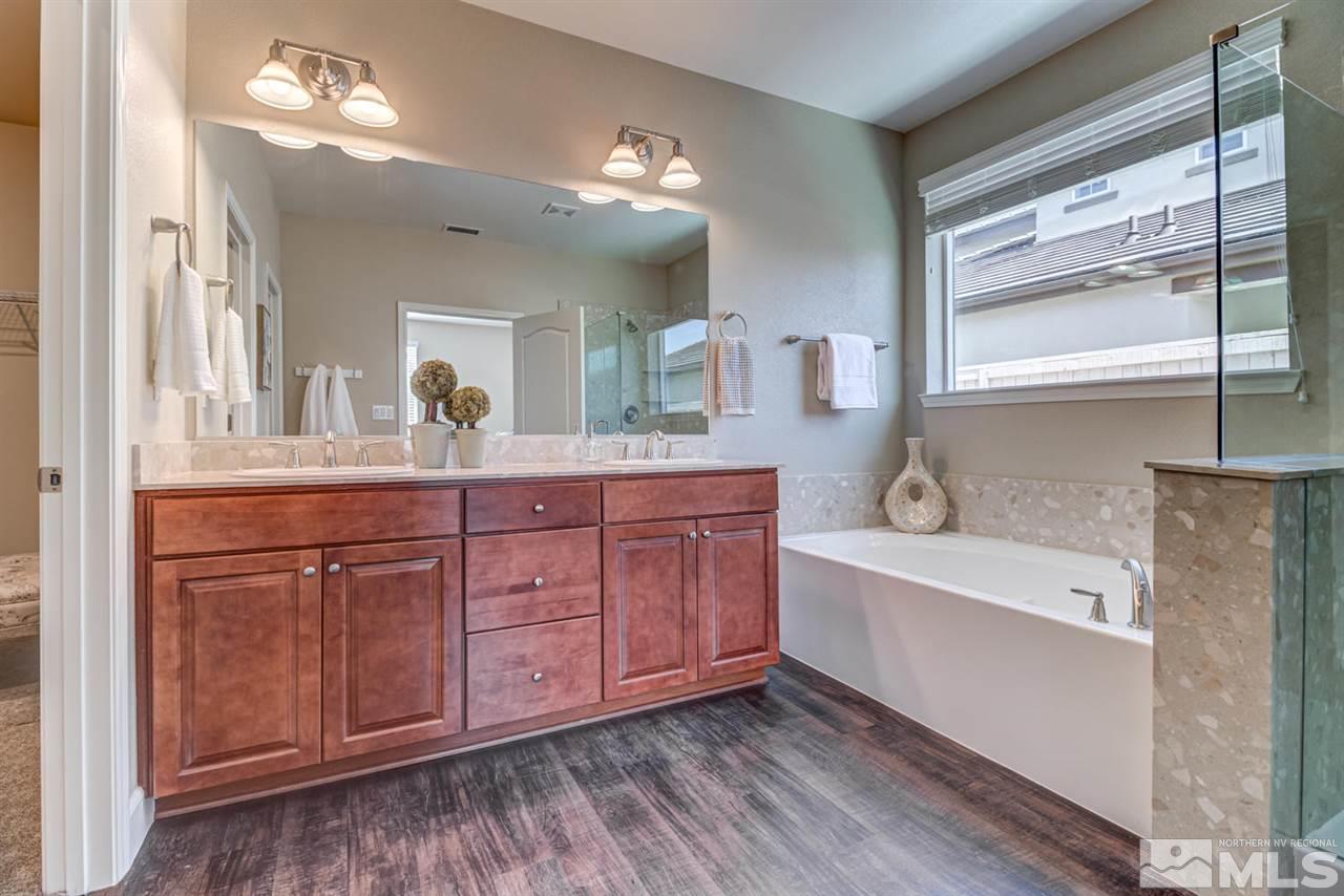10290 Culiacan Pass Trail Reno, NV 89521 - Photo 14 of 23 a spacious bathroom with a tub double vanity sink and a large mirror