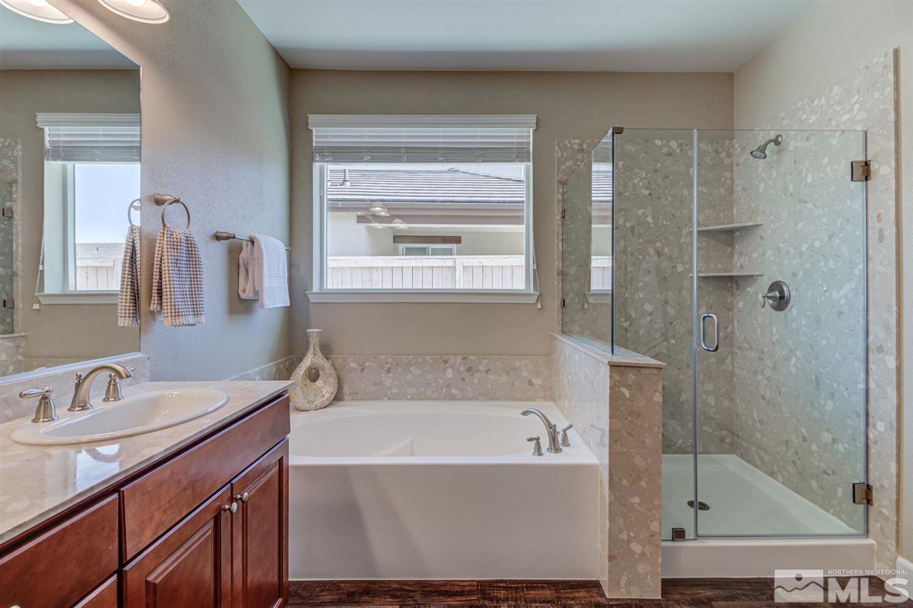 10290 Culiacan Pass Trail Reno, NV 89521 - Photo 15 of 23 a bathroom with a bathtub shower sink and mirror