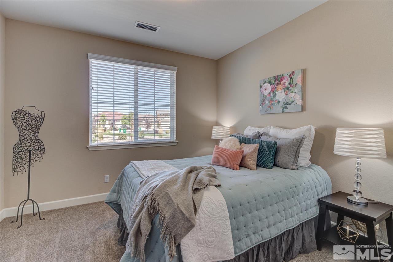 10290 Culiacan Pass Trail Reno, NV 89521 - Photo 18 of 23 a bed sitting in a bedroom next to a window