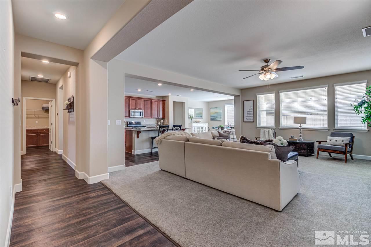10290 Culiacan Pass Trail Reno, NV 89521 - Photo 3 of 23 a living room with couches and kitchen view with wooden floor