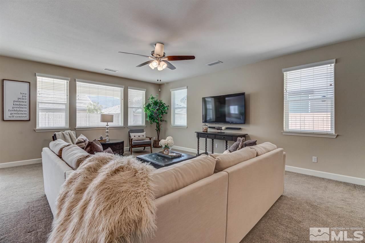 10290 Culiacan Pass Trail Reno, NV 89521 - Photo 4 of 23 a living room with furniture a large window and a flat screen tv