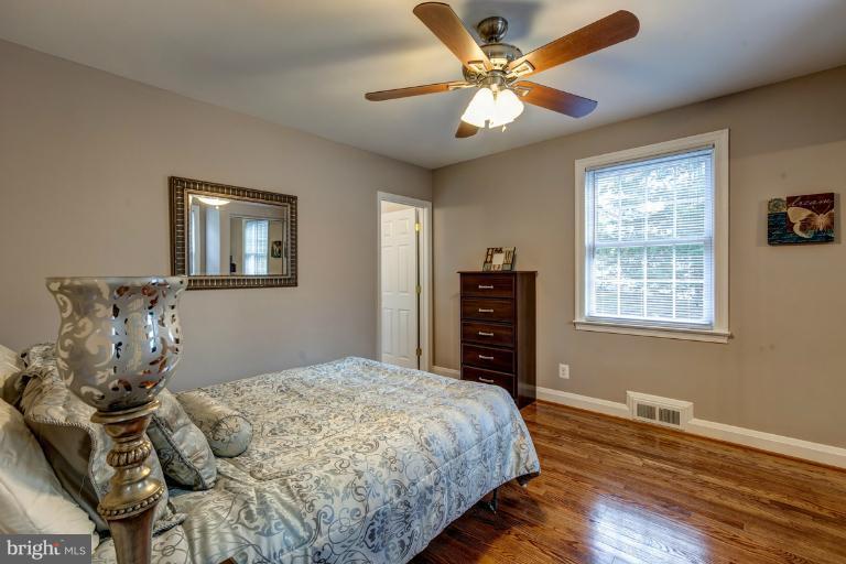1010 Hart Road Baltimore, MD 21286 - Photo 14 of 30 a bedroom with a bed and a chandelier