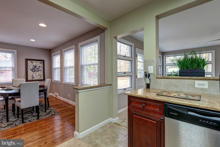 1010 Hart Road Baltimore, MD 21286 - Photo 16 of 30 a open kitchen with granite countertop a stove and wooden floor