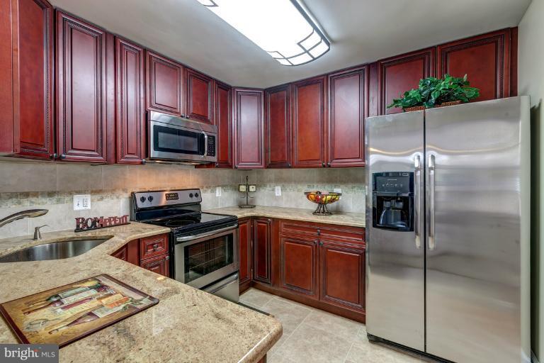1010 Hart Road Baltimore, MD 21286 - Photo 21 of 30 a kitchen with a refrigerator stove top oven a sink and dishwasher