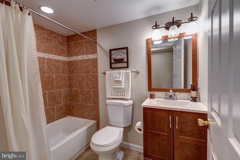 1010 Hart Road Baltimore, MD 21286 - Photo 26 of 30 a bathroom with a sink a toilet and shower