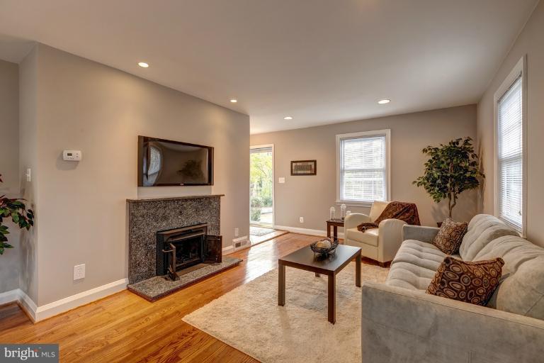 1010 Hart Road Baltimore, MD 21286 - Photo 27 of 30 a living room with furniture a flat screen tv and a fireplace