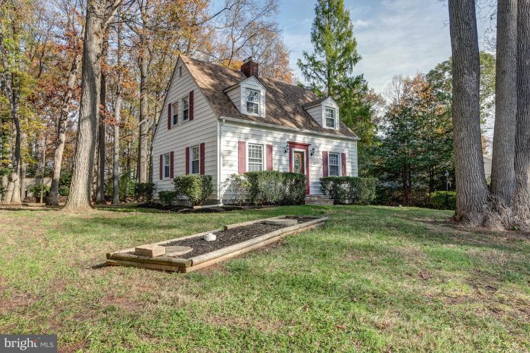 1010 Hart Road Baltimore, MD 21286 - Photo 5 of 30 a view of a white house next to a yard with big trees