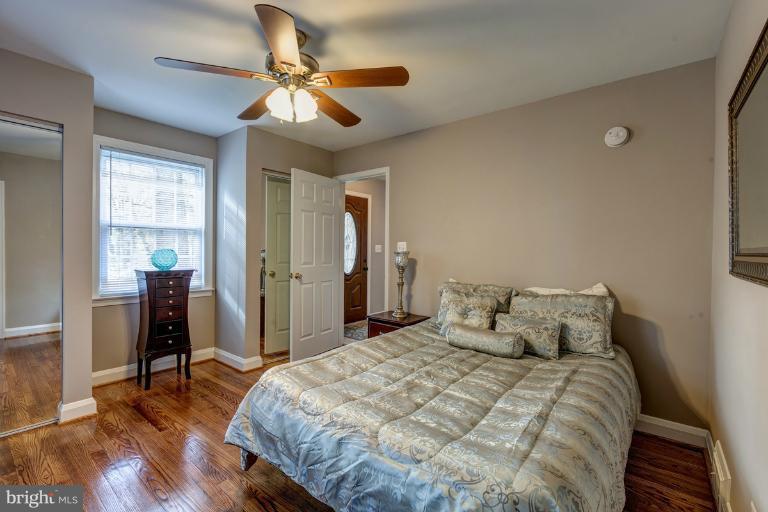 1010 Hart Road Baltimore, MD 21286 - Photo 6 of 30 a bedroom with a bed and a chandelier