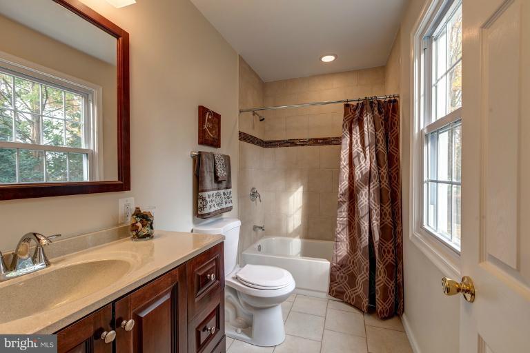 1010 Hart Road Baltimore, MD 21286 - Photo 7 of 30 a bathroom with a granite countertop sink toilet and shower