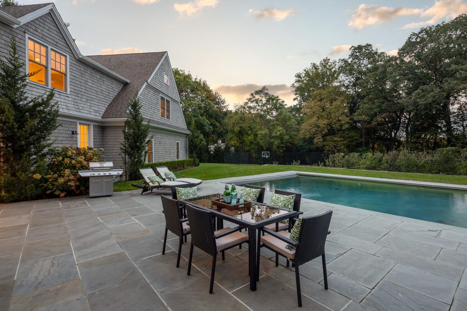 35 Prospect Road Westport, CT 06880 - Photo 39 of 40 a backyard of a house with yard and outdoor seating