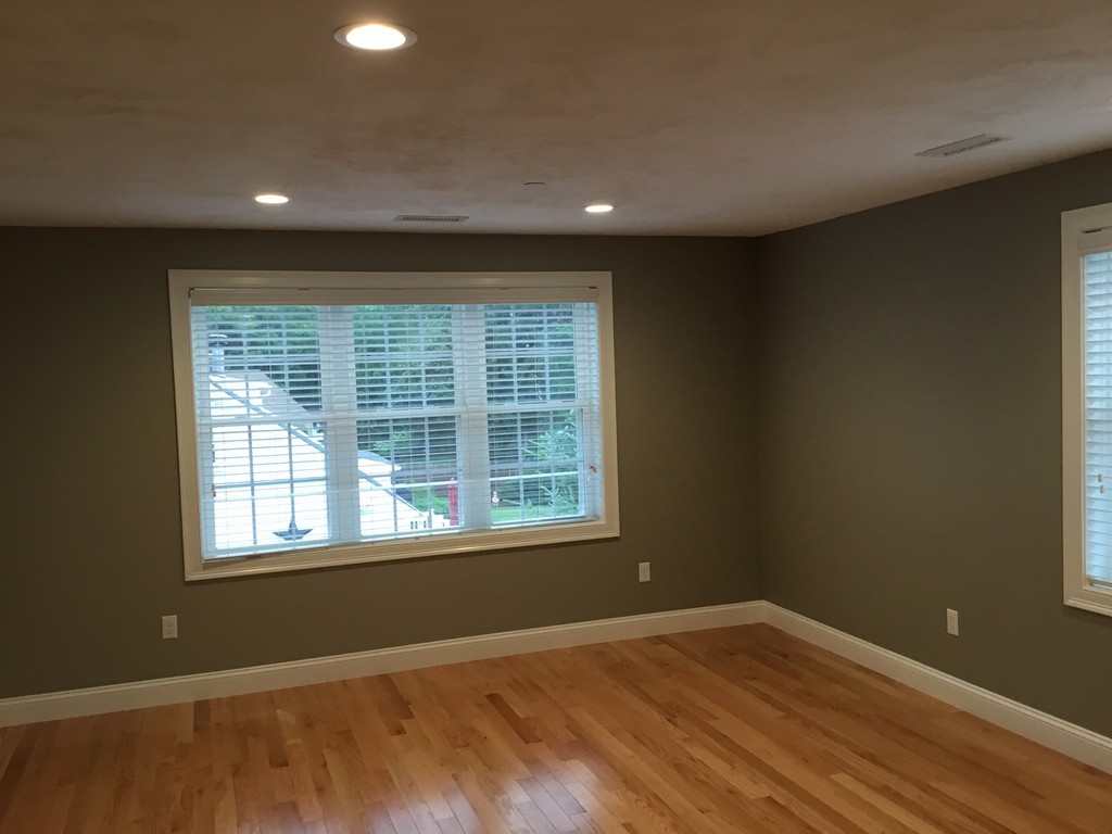 83 D Maple Avenue, Unit D Rutland, MA 01543 - Photo 4 of 12 a view of an empty room with wooden floor and a window