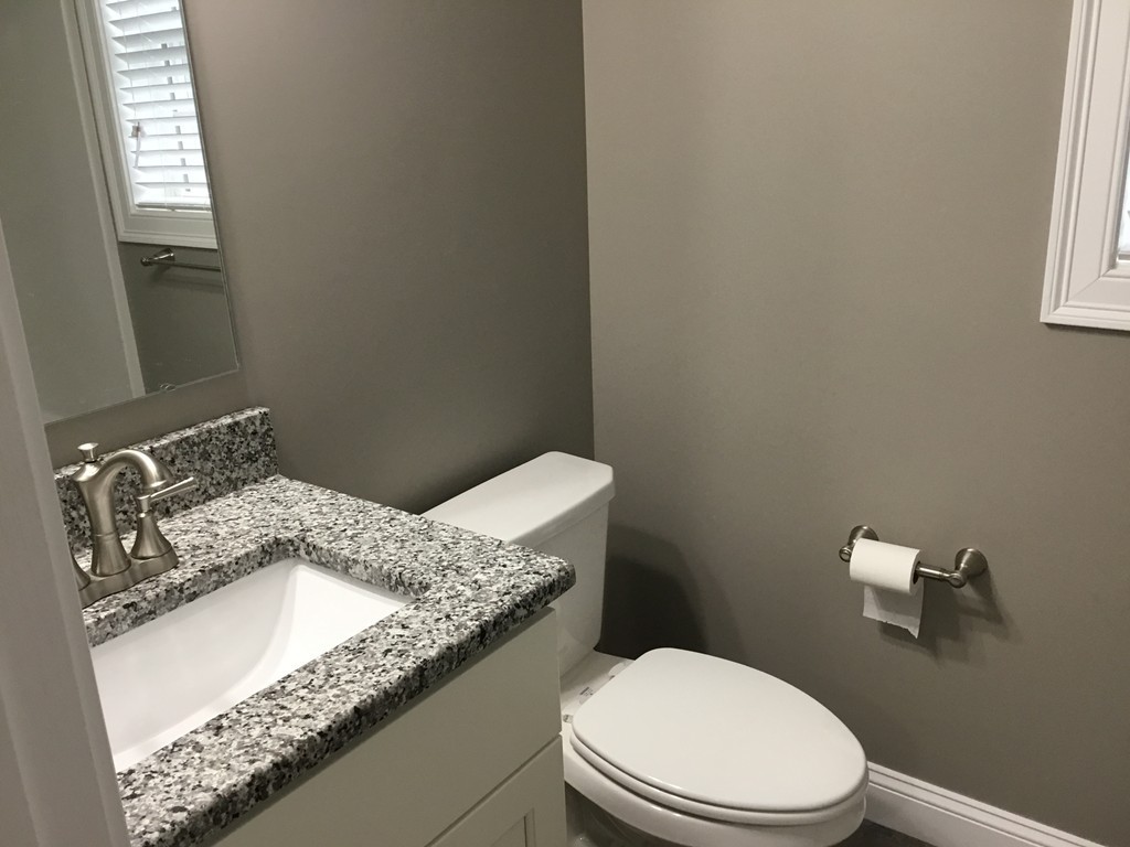 83 D Maple Avenue, Unit D Rutland, MA 01543 - Photo 10 of 12 a bathroom with a granite countertop sink a mirror and a toilet